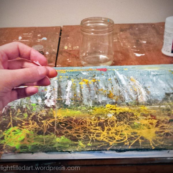 Using paint-soaked string to paint bushes