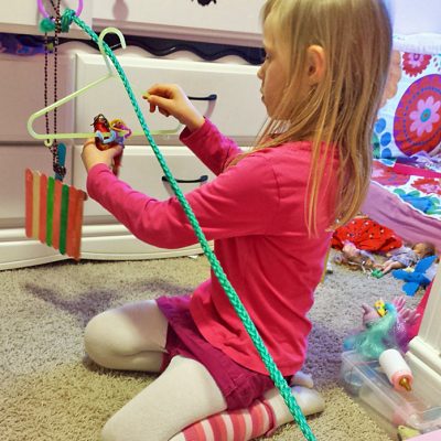     After realizing she could not build a full-sized zip line in our yard with this piece of rope, my daughter made a small one for the dolls.  zip line dolls